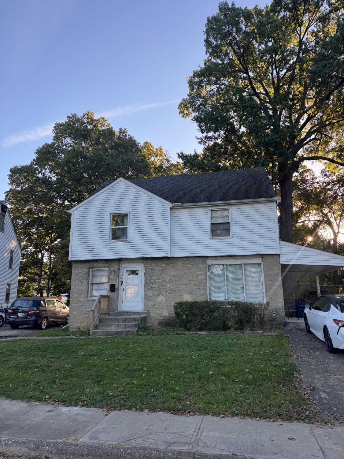 Two-storey duplex in Columbus with white siding and a stone ground floor